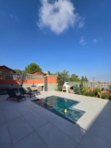 a patio with a swimming pool on top of a house at Estia Mylona in Ayios Therapon