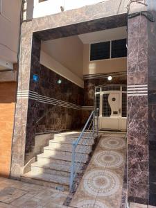 a set of stairs in a building with a gate at Appartement proche toutes commodités in Berkane