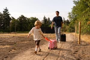 a man and a little boy pulling a pink suitcase at Eco by Nature - De Adem - in Heythuysen