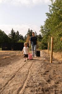 a man and a little girl walking down a dirt road at Eco by Nature - De Adem - in Heythuysen