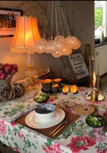a table with a plate of food and two lamps at Stadtvilla Annabelle - mit Sauna in Meschede