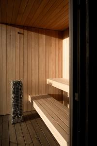 a sauna with a heater in a wooden room at Eco by Nature - De Adem - in Heythuysen