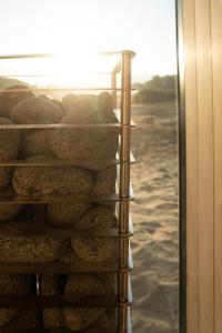 a bunch of breads in a rack next to the water at Eco by Nature - De Adem - in Heythuysen +28 photos