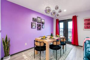 a dining room with purple walls and a table with chairs at Chic Nashville Retreat, River Views and VIP Vibes in Nashville