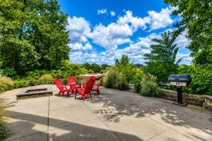 a group of red chairs sitting on a patio at Chic Nashville Retreat, River Views and VIP Vibes in Nashville