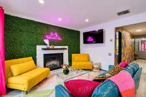 a living room with yellow furniture and a green wall at Chic Nashville Retreat, River Views and VIP Vibes in Nashville