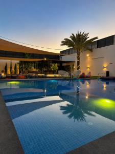 a swimming pool in a hotel at night at Madrid Luxury Villa in Al Rama
