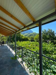 a covered porch with a view of a mountain at Mountain House Përmet 