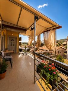 an outdoor patio with an umbrella and some flowers at Apartments Maja in Star Dojran