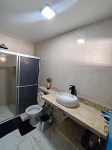 a bathroom with a toilet and a shower and a sink at Dunas House in Luis Correia +14 photos