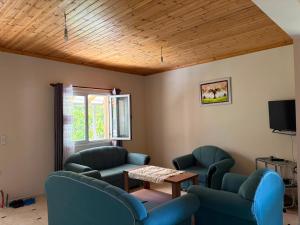 a waiting room with blue chairs and a table at Mountain House Përmet 