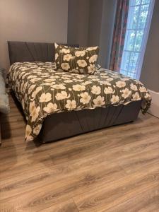 a bed in a room with a wooden floor at Viking Triangle in Waterford