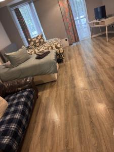 a living room with two beds and a hard wood floor at Viking Triangle in Waterford
