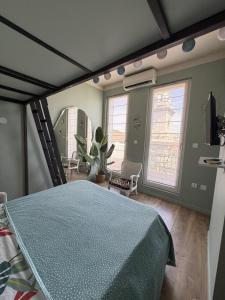 a bedroom with a bed with a blue comforter at Les Terrasses, charme et authenticité en Hyper Centre de TOULON, Idéal pour un séjour romantique ou une escapade urbaine in Toulon