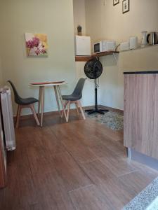 a room with two chairs and a table and a fan at Casa dos Ramos in Rio de Fornos