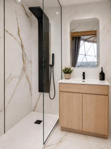 a bathroom with a shower and a sink at Sodade Eco Camp in Portela
