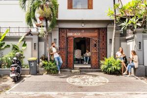 a group of people standing outside of a building at Alma by iVAVev in Mamaia