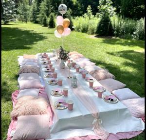 a long white table with pillows and balloons on it at Golden Hour in Cockburn Harbour