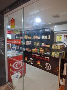 a display case in a store with some food at Flat à beira mar, charmoso e aconchegante in João Pessoa
