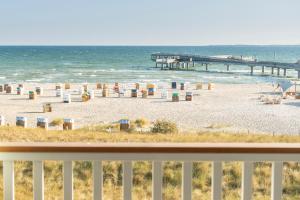 a view of the beach from a balcony at Hotel Restaurant Nordpol in Heiligenhafen