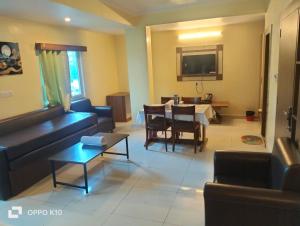 a living room with a couch and a table at Hotel ashtha inn in Gaya