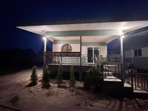 a house with a lit up porch at night at PATTARAWAN House in Thong Sala