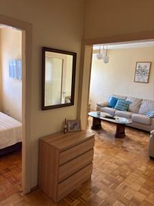 a living room with a couch and a mirror at Sweet dreams apartment in Bar