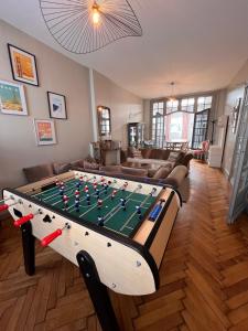a living room with a foosball table at Charme et confort - Maison Roubaix 5 chambres in Roubaix