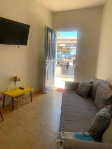 a living room with a couch and a table at Blue Door Hideaway in Moutsoúna +5 photos