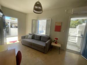 a living room with a couch and a table at Blue Door Hideaway in Moutsoúna