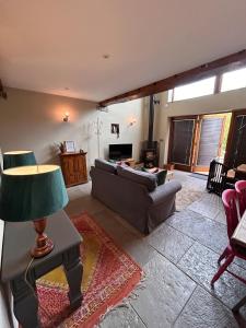 a living room with a couch and a table at The Hayloft at Stathe Farm in Bridgwater