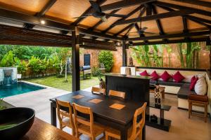 a living room with a couch and a table at Alanta Private Pool Villa in Ko Lanta