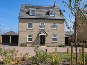 a brick house with a gambrel roof at Stepping Stone in Ashbourne