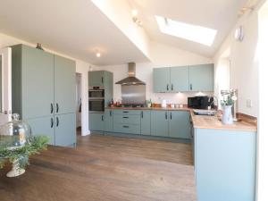a kitchen with blue cabinets and a counter top at Stepping Stone in Ashbourne