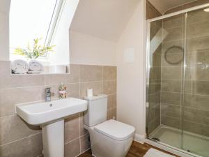 a bathroom with a toilet and a sink and a shower at Stepping Stone in Ashbourne +26 photos