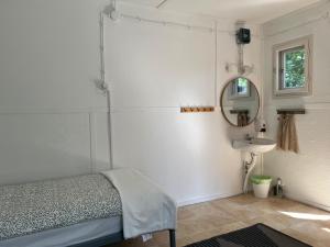 a bedroom with a bed and a mirror and a sink at Gedeon Garden in Budakalász