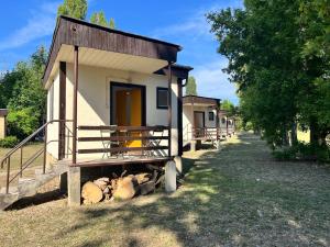 a small house with a pile of logs in front of it at Gedeon Garden in Budakalász