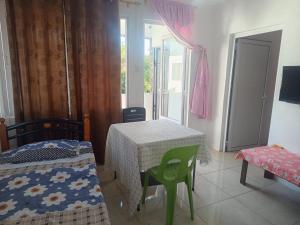 a room with a table and two chairs and a window at First floor apartment with view and balcony and with charming pool near sandy beach and commerces in Pointe aux Biches