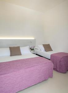 two beds sitting next to each other in a room at Hotel Leonardo da Vinci in Pesaro +16 photos