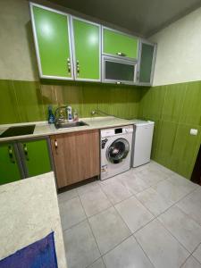 a kitchen with a washing machine and a sink at Poti apartment in Poti
