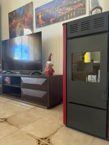 a teddy bear is sitting next to a television at Giardino di Chiara al mare in Torre Rinalda