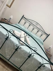 a bed with two white shoes sitting on it at Giardino di Chiara al mare in Torre Rinalda