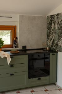 a kitchen with a stove top oven in a room at The Lake Escape - Trevignano in Trevignano Romano
