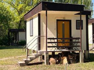 a tiny house with a staircase and a door at Gedeon Garden in Budakalász +33 photos