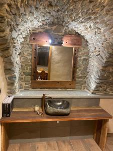 a stone bathroom with a sink and a mirror at Affittacamere L'Abri in Etroubles +37 photos