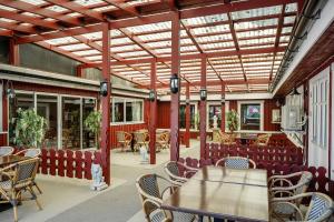 a dining room with tables and chairs and a ceiling at Hillesgården in Boarp +69 photos