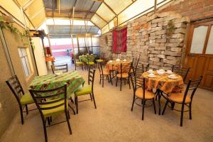 a dining room with tables and chairs and a brick wall at Hostal Terra Sal - Bed, Breakfast, Garage & Salar de Uyuni Tours in Uyuni