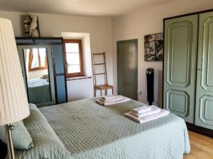 a bedroom with a bed with two towels on it at La Salvia in Scansano