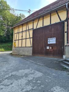 a building with a large door with a sign on it at Zimmer auf'm Hof in Gerabronn +5 photos