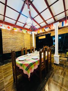 a dining room with a table and chairs in a room at Tuskers edge Retreat in Udawalawe